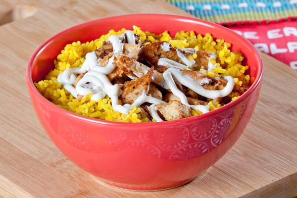 A plate of seasoned rice with chicken strips